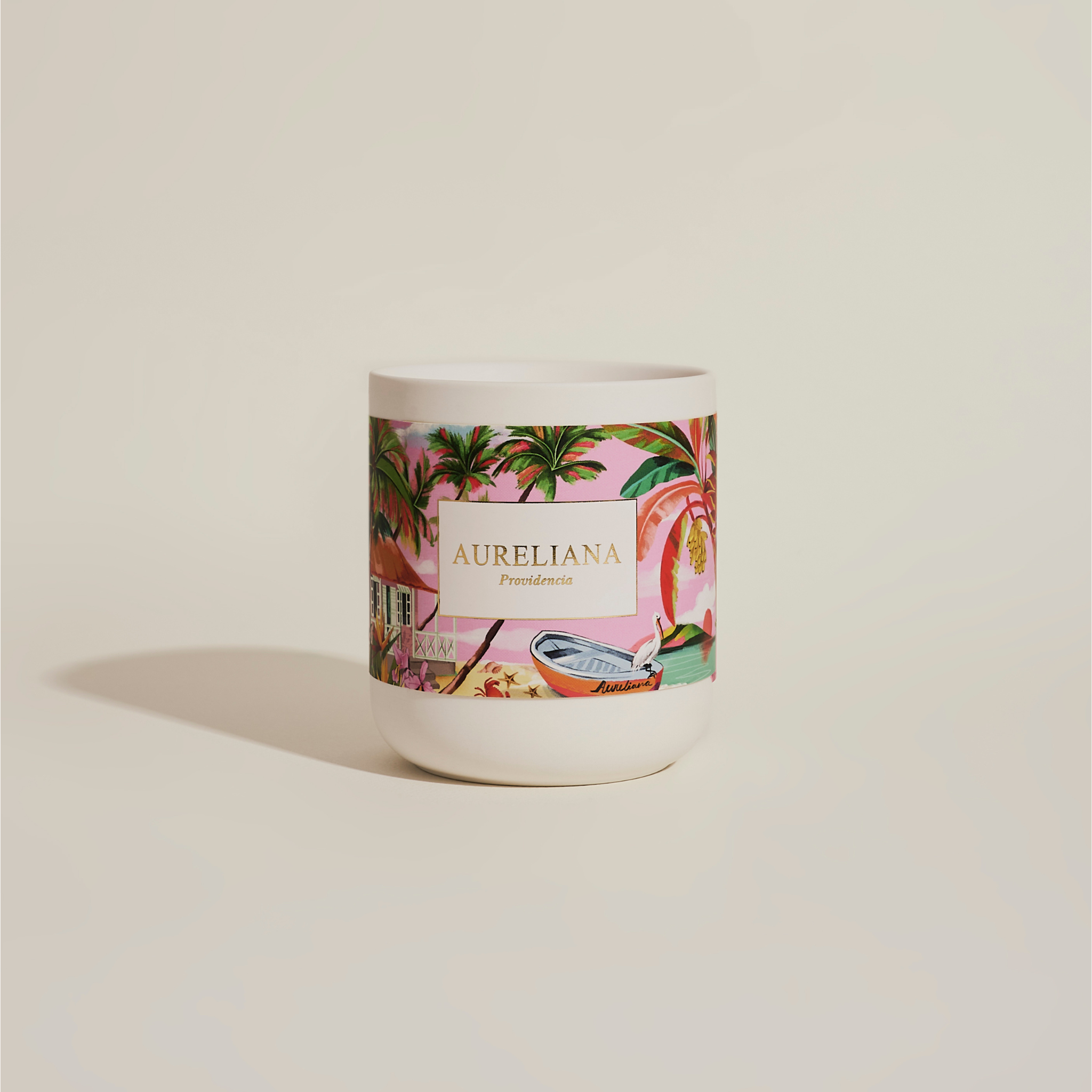 Candle with a colorful label featuring palm trees and the brand name 'Aureliana' on a beige background.