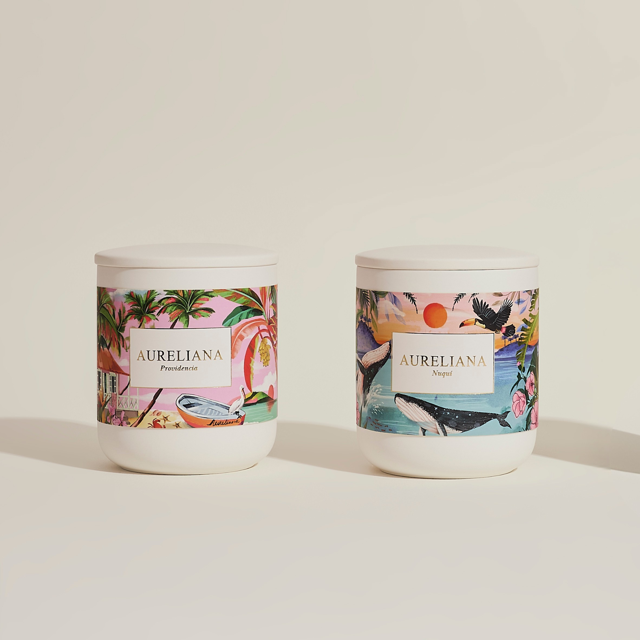 Two candles with decorative labels on a light background